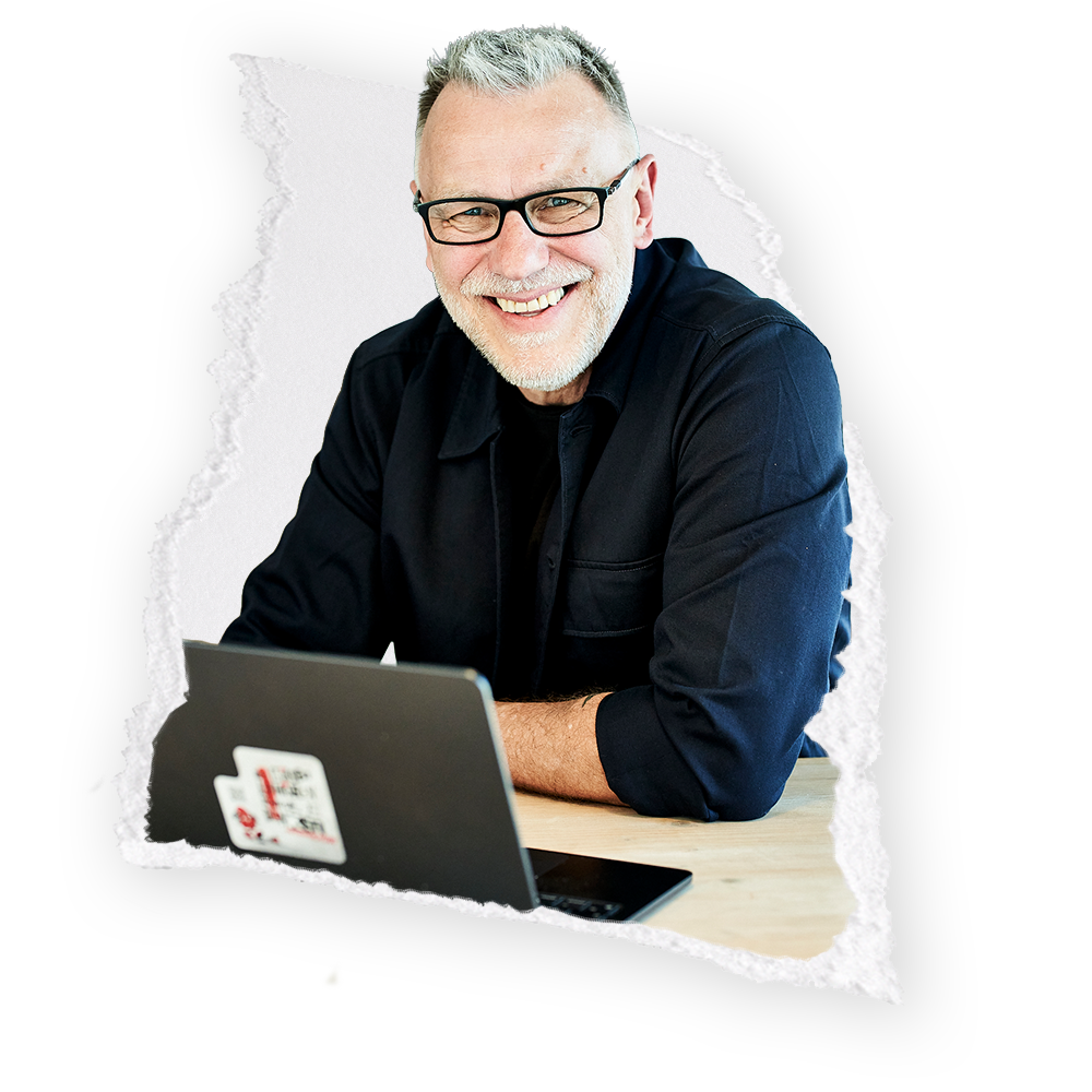 Lächelnder Zahnarzt mit Laptop bei Marketing und Patientenkommunikation